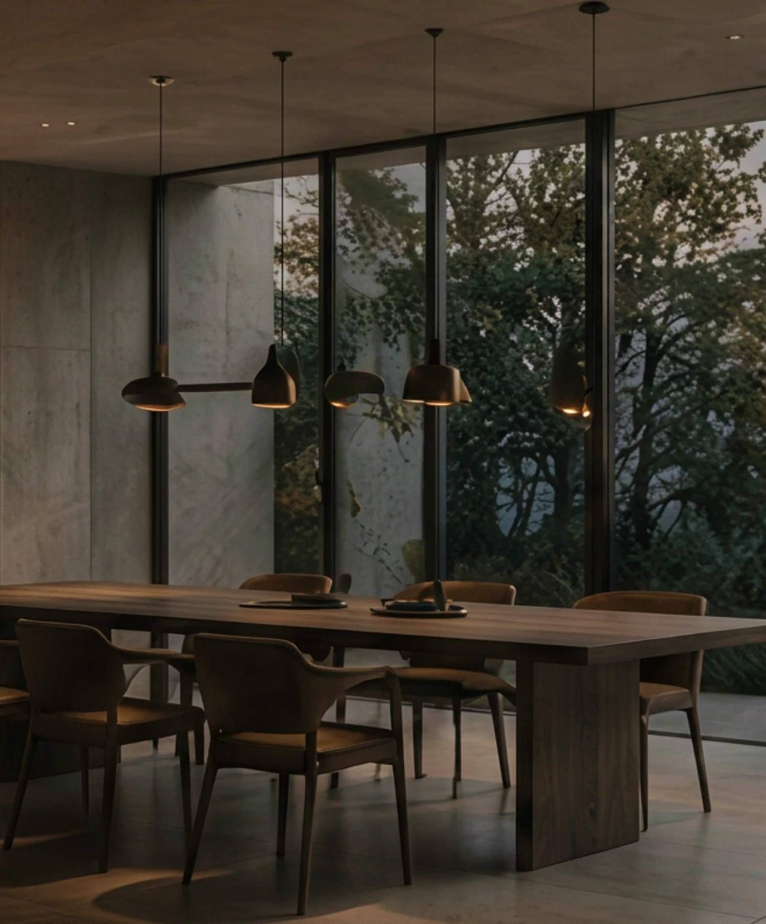 Dining room with pendant lights facing woodland
