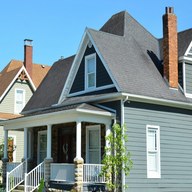 Roofer locking a standing-seam panel in Hood River