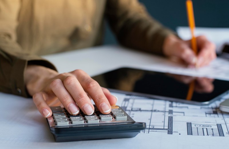 Estimator pricing a re-roof over printed plans